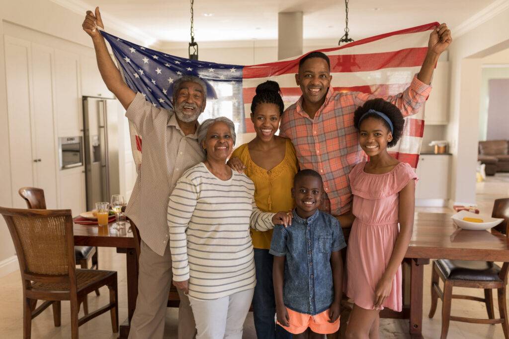 family holding an american flag in a home